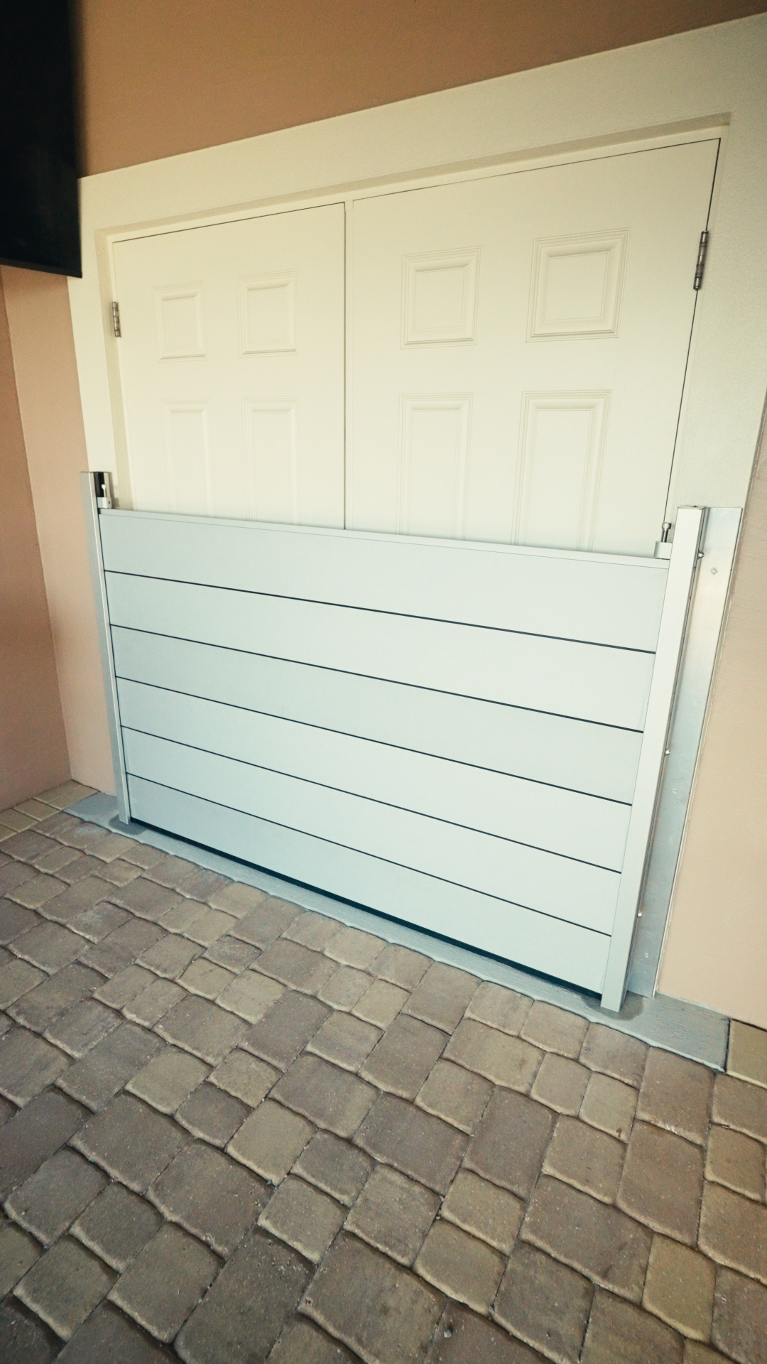 Modern Florida home protected by an installed residential flood gate barrier